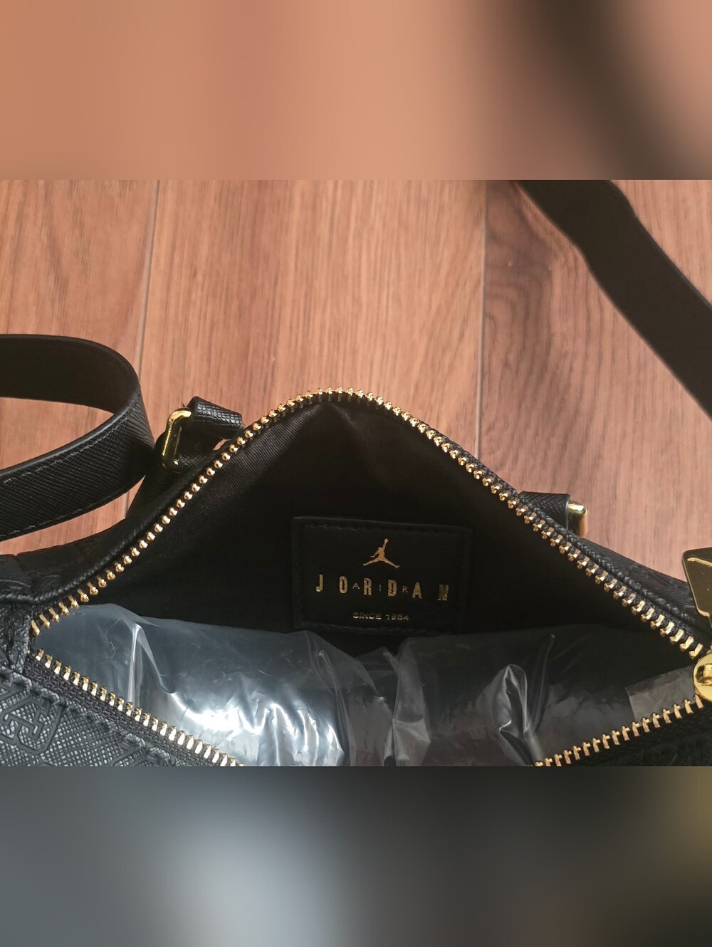 A black Jordan Monogram Mini Duffle Bag With Jump Man On It - Picture 8 of 10